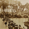 Photograph from Stordy - From Nairobi to the Red Sea, showing porters fording the Guaso Nyero